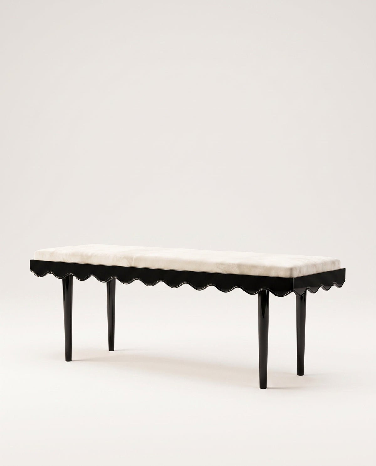 Romance upholstered bench in ecru velvet with scalloped skirt and black lacquer legs, Monde Singulier Editions, three-quarter view