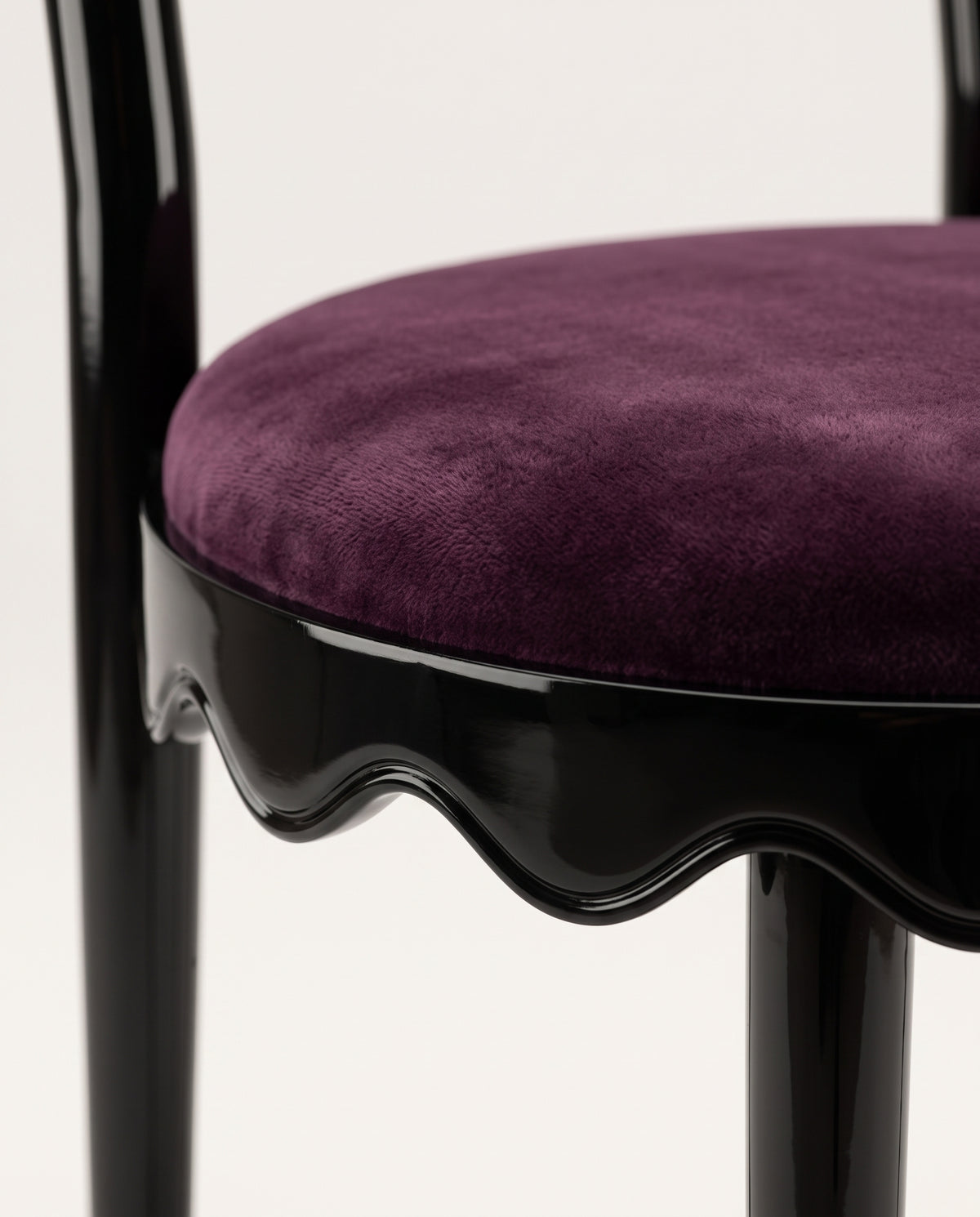 Romance chair, close-up of the round aubergine velvet seat and scalloped black lacquer skirt, Monde Singulier Editions