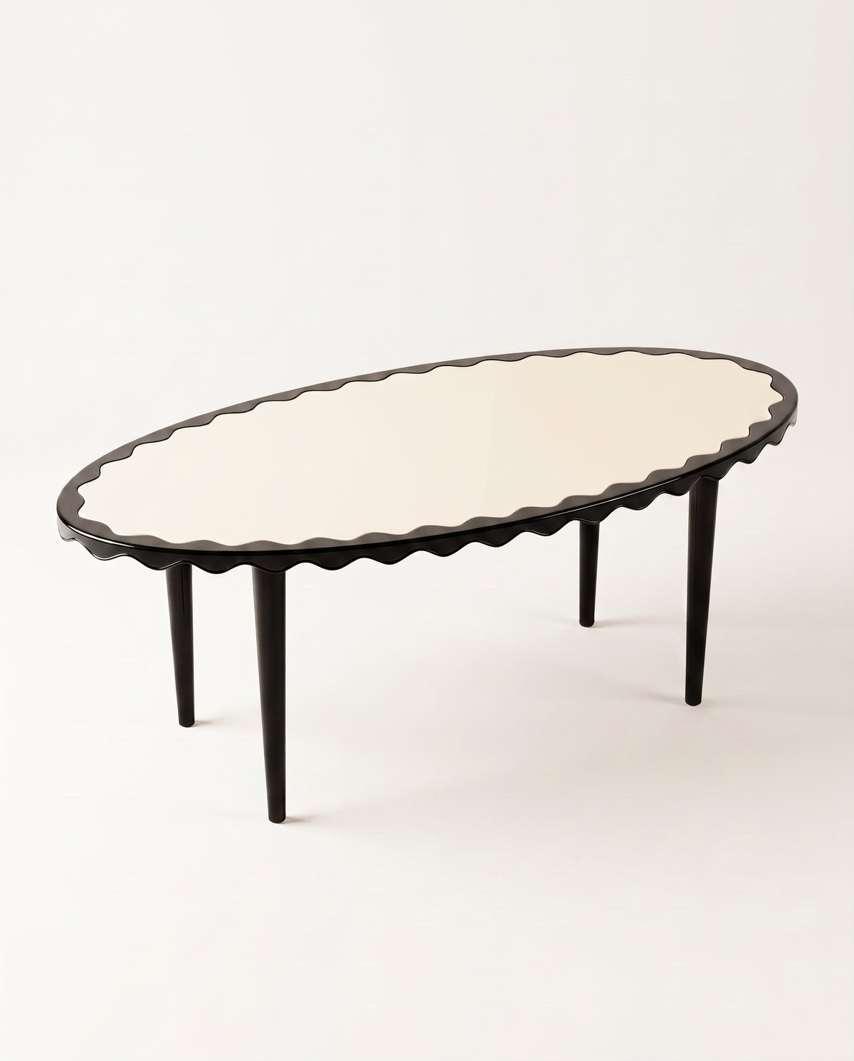 Romance oval dining table in black lacquer, elevated view showing the scalloped edge running the full perimeter, Monde Singulier Editions