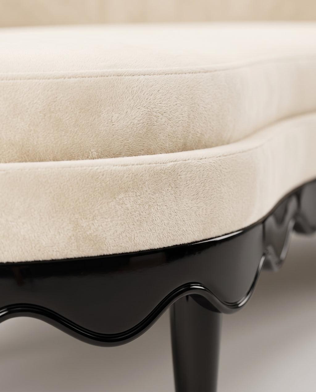 Romance sofa in ecru velvet, close-up of the seat cushion edge and scalloped black lacquer base, Monde Singulier Editions