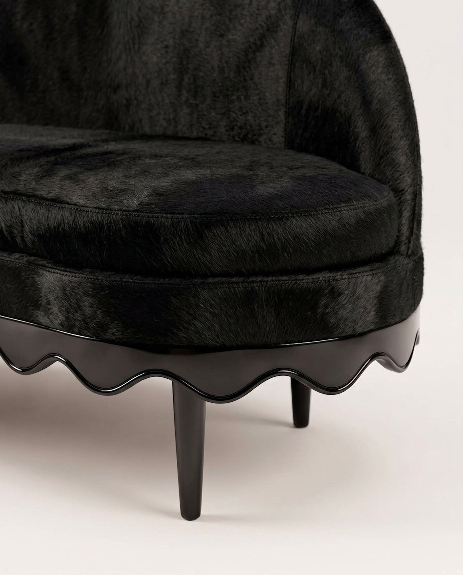 Romance sofa in black cow leather, close-up of the scalloped black lacquer base and turned legs, Monde Singulier Editions
