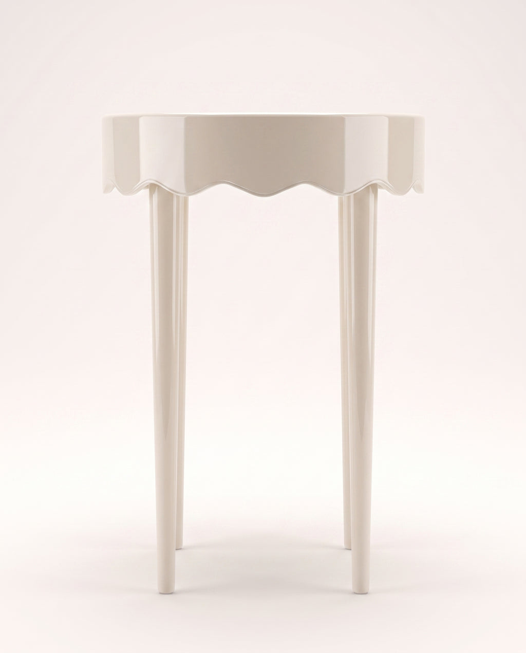 Romance round side table in off-white lacquer with scalloped apron and three tapered legs, Monde Singulier Editions, front view