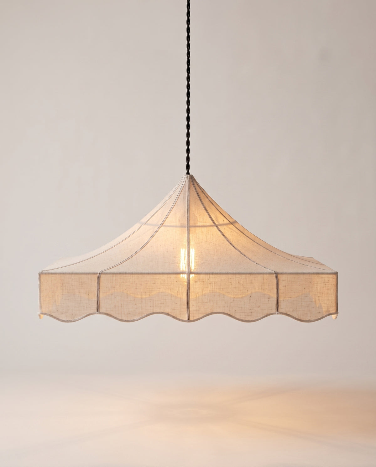 Romance pendant lamp lit, soft even light through the scalloped off-white paper shade, Monde Singulier Editions