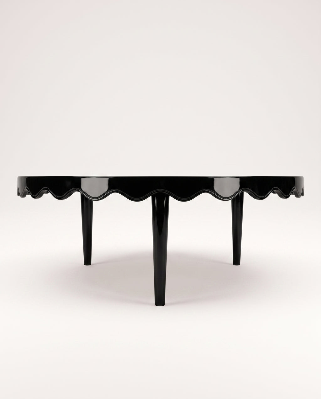 Romance coffee table in black lacquer, side view of the scalloped apron and tapered legs, Monde Singulier Editions